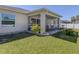 Exterior view of the home showcasing the screened patio and spacious backyard at 2098 Zellwood Ter, North Port, FL 34286
