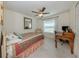 Bright bedroom with ceiling fan, window, and desk for an ideal workspace or relaxing retreat at 2098 Zellwood Ter, North Port, FL 34286