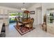 Elegant dining room with wooden furniture, a chandelier, and sliding glass doors to patio at 2098 Zellwood Ter, North Port, FL 34286