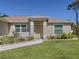 Inviting front entrance with a neutral colored door, manicured flower bed and a walkway at 2098 Zellwood Ter, North Port, FL 34286