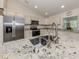 Well-lit kitchen featuring granite counters, stainless steel appliances and plenty of cabinet space at 2098 Zellwood Ter, North Port, FL 34286