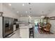 Bright open kitchen featuring a view into the dining room, with stainless steel appliances at 2098 Zellwood Ter, North Port, FL 34286