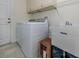 Convenient laundry room with a washer, dryer, utility sink, and plenty of storage space at 2098 Zellwood Ter, North Port, FL 34286
