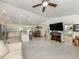Open-concept living space with tile floors seamlessly connects the kitchen, dining area, and Gathering room for easy living at 2098 Zellwood Ter, North Port, FL 34286