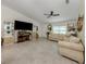 Neutral color palette and tile floors make this living room a versatile and inviting space for relaxation and entertainment at 2098 Zellwood Ter, North Port, FL 34286