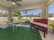 Relaxing screened patio with a seating area and a peaceful view of the lush backyard at 2098 Zellwood Ter, North Port, FL 34286