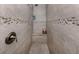 Tiled walk-in shower with bench and accent tile, offering a luxurious and convenient space at 2098 Zellwood Ter, North Port, FL 34286