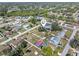 Wide aerial shot showcasing a neighborhood with mature landscaping and a community pool at 2102 Alaric St, Port Charlotte, FL 33952