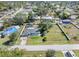 Aerial view of the home with a large yard, bordered with white fence at 2102 Alaric St, Port Charlotte, FL 33952