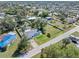 Aerial view of the property showing the house, pool, and large fenced yard at 2102 Alaric St, Port Charlotte, FL 33952
