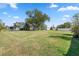 Expansive backyard featuring a large grassy area and mature trees at 2102 Alaric St, Port Charlotte, FL 33952