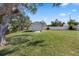 A shed in the backyard, surrounded by lush greenery and a privacy fence at 2102 Alaric St, Port Charlotte, FL 33952