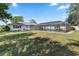 Sprawling backyard featuring mature trees and screened in pool for outdoor enjoyment at 2102 Alaric St, Port Charlotte, FL 33952