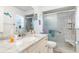 Clean bathroom featuring a walk-in shower with seat, marble countertop, and a large mirror at 2102 Alaric St, Port Charlotte, FL 33952