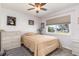 Well-lit bedroom with a ceiling fan, closet space, and a window with view of the neighborhood at 2102 Alaric St, Port Charlotte, FL 33952