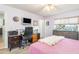Comfortable bedroom with desk and TV, window with blinds, and light purple walls at 2102 Alaric St, Port Charlotte, FL 33952