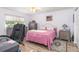 Cozy bedroom with a ceiling fan, closet space, comfortable bed, and a nearby desk at 2102 Alaric St, Port Charlotte, FL 33952