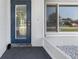Inviting entryway with a blue glass-paneled door and decorative stone accents at 2102 Alaric St, Port Charlotte, FL 33952