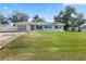 Charming single-story home with a well-maintained lawn and blue shutters at 2102 Alaric St, Port Charlotte, FL 33952