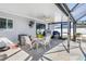 Screened patio dining area with ceiling fan features a mini refrigerator at 2102 Alaric St, Port Charlotte, FL 33952