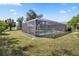 A screened in pool enclosure provides year-round enjoyment, privacy, and protection from insects and sun at 2102 Alaric St, Port Charlotte, FL 33952