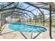 Sparkling pool in screened enclosure with surrounding patio and backyard at 2102 Alaric St, Port Charlotte, FL 33952