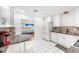 Cozy kitchen features white cabinets, tile flooring, granite countertops and passthrough to the sun room at 2209 Woodmere Rd, Venice, FL 34293