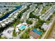 Aerial view of a vast neighborhood and surrounding waterways with a community pool and tennis courts at 223 Lancer Dr, Nokomis, FL 34275