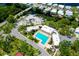 Aerial view of community pool, boat storage, and houses in a neighborhood with winding canals at 223 Lancer Dr, Nokomis, FL 34275