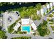 Aerial view of community pool, boat storage, and parking area with mature trees and landscaping at 223 Lancer Dr, Nokomis, FL 34275