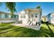 Backyard featuring well-maintained lawn and small deck with access to the home at 223 Lancer Dr, Nokomis, FL 34275