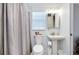 Cozy bathroom featuring a pedestal sink, toilet, and a window with natural light at 223 Lancer Dr, Nokomis, FL 34275