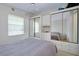 Spacious bedroom features large mirrored closet doors and a comfortable bed at 223 Lancer Dr, Nokomis, FL 34275