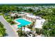 Aerial shot showcasing a sparkling community pool with lounge chairs and lush landscaping at 223 Lancer Dr, Nokomis, FL 34275