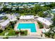 Aerial view of a sparkling community pool with ample lounging space and attractive landscaping at 223 Lancer Dr, Nokomis, FL 34275