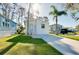 Charming single-story home with lush green lawn, complemented by mature trees and a bright facade at 223 Lancer Dr, Nokomis, FL 34275