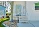 Inviting front entrance with stone-accented steps, decorative glass door, and adjacent landscaping at 223 Lancer Dr, Nokomis, FL 34275