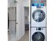 Convenient laundry area with stackable washer and dryer, and storage space at 223 Lancer Dr, Nokomis, FL 34275