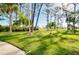 View of a lush, manicured lawn with trees and clear blue skies, perfect for outdoor enjoyment at 223 Lancer Dr, Nokomis, FL 34275