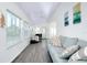 Bright living room with vaulted ceilings, laminate floors, and lots of natural light at 223 Lancer Dr, Nokomis, FL 34275