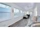 Bright, open living area featuring laminate flooring and ample natural light from large windows at 223 Lancer Dr, Nokomis, FL 34275