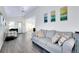 Spacious living room with laminate floors, vaulted ceilings, and stylish decor at 223 Lancer Dr, Nokomis, FL 34275