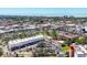 Aerial view showcasing the real estate's surroundings, including trees, parking, and the ocean at 238 Tampa W Ave # 217, Venice, FL 34285