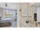Well-lit bathroom with a sink, cabinet, and a peek into the adjacent bedroom at 238 Tampa W Ave # 217, Venice, FL 34285