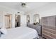 Bright bedroom featuring wicker furniture, an open closet, and glimpses of the kitchen at 238 Tampa W Ave # 217, Venice, FL 34285