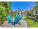 Community seating area featuring adirondack chairs, a grill, and lush tropical landscaping at 238 Tampa W Ave # 217, Venice, FL 34285