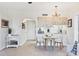 Charming dining area and kitchen featuring tiled floors and sleek white cabinetry at 238 Tampa W Ave # 217, Venice, FL 34285