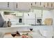Well-lit kitchen with white appliances, sleek countertops, and a cozy dining area at 238 Tampa W Ave # 217, Venice, FL 34285