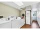 Community laundry room with multiple washers, dryers, and storage lockers at 238 Tampa W Ave # 217, Venice, FL 34285
