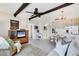 Cozy living room with a tv, accent chair, and a view into the open kitchen and dining area at 238 Tampa W Ave # 217, Venice, FL 34285